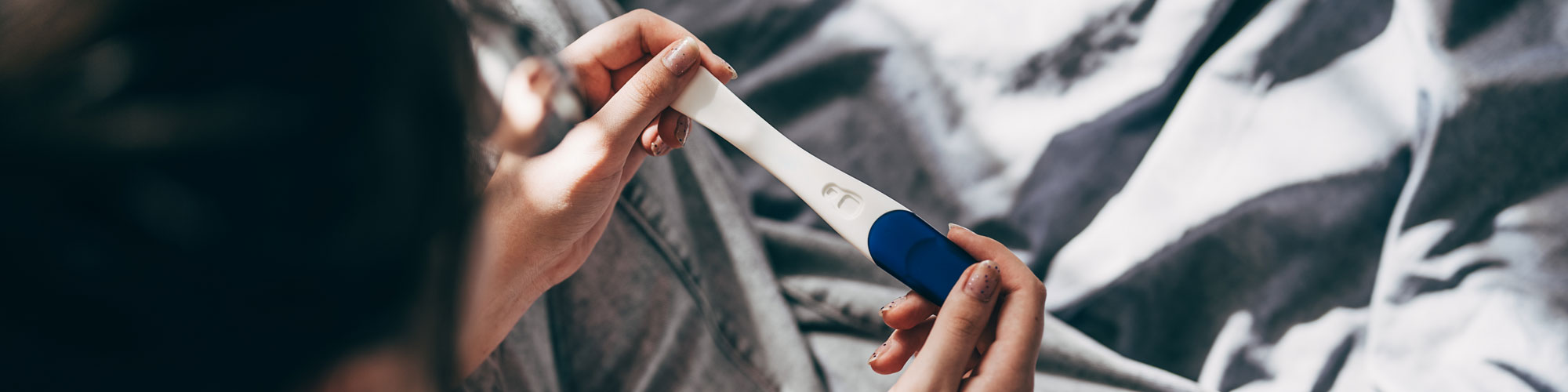 Rear View Cropped Shot Of Unrecognizable Woman Taking Pregnancy Test At Home