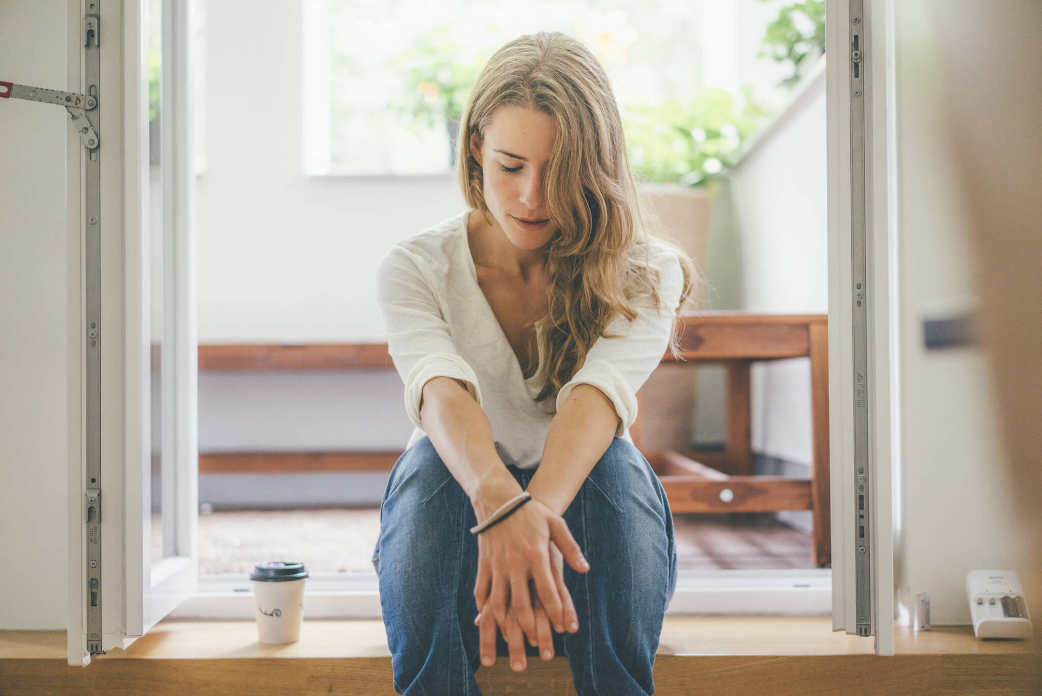 Young Woman With Takeaway Coffee Sitting At Balcony Young Woman With Takeaway Coffee Sitting At Balcony