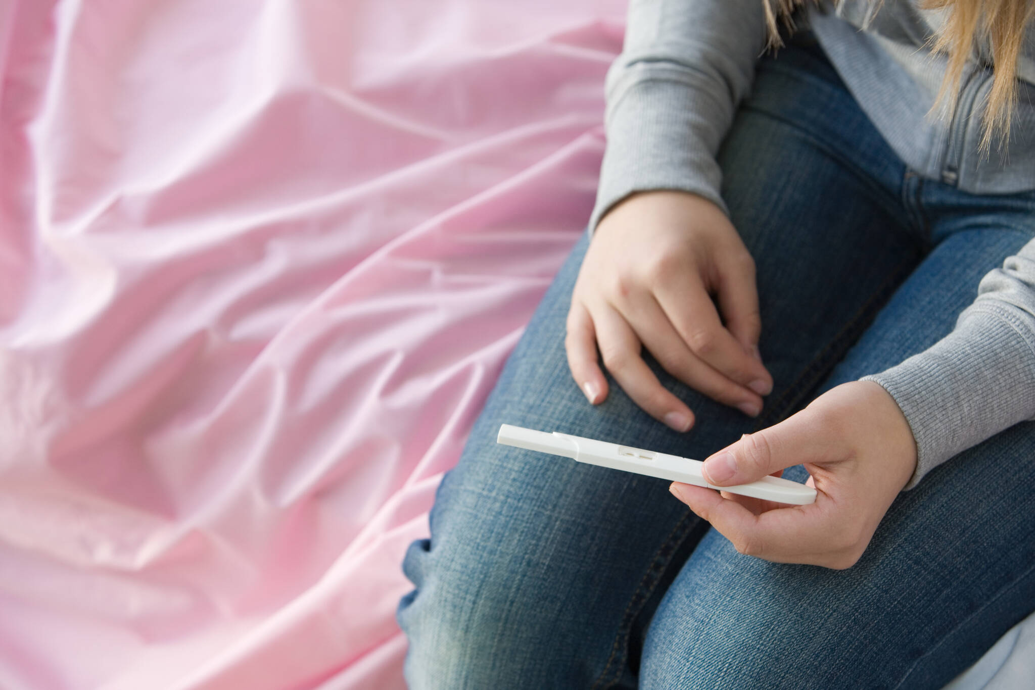 A Teenage Girl Holding A Pregnancy Test