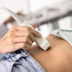 Hand Of Doctor Driving Ultrasound Scanner Sensor On Patient Belly