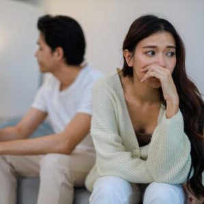 The Asian Couple Getting Upset With Each Other In Bedroom.